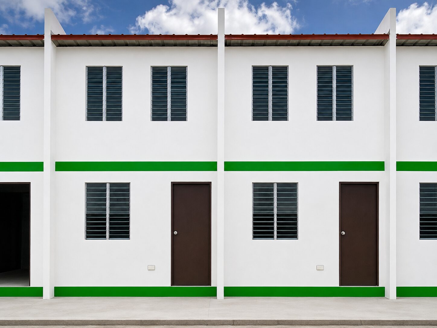 Socialized units at Arira Homes Babag in the Green Genie scheme, with louvred windows and brown doors