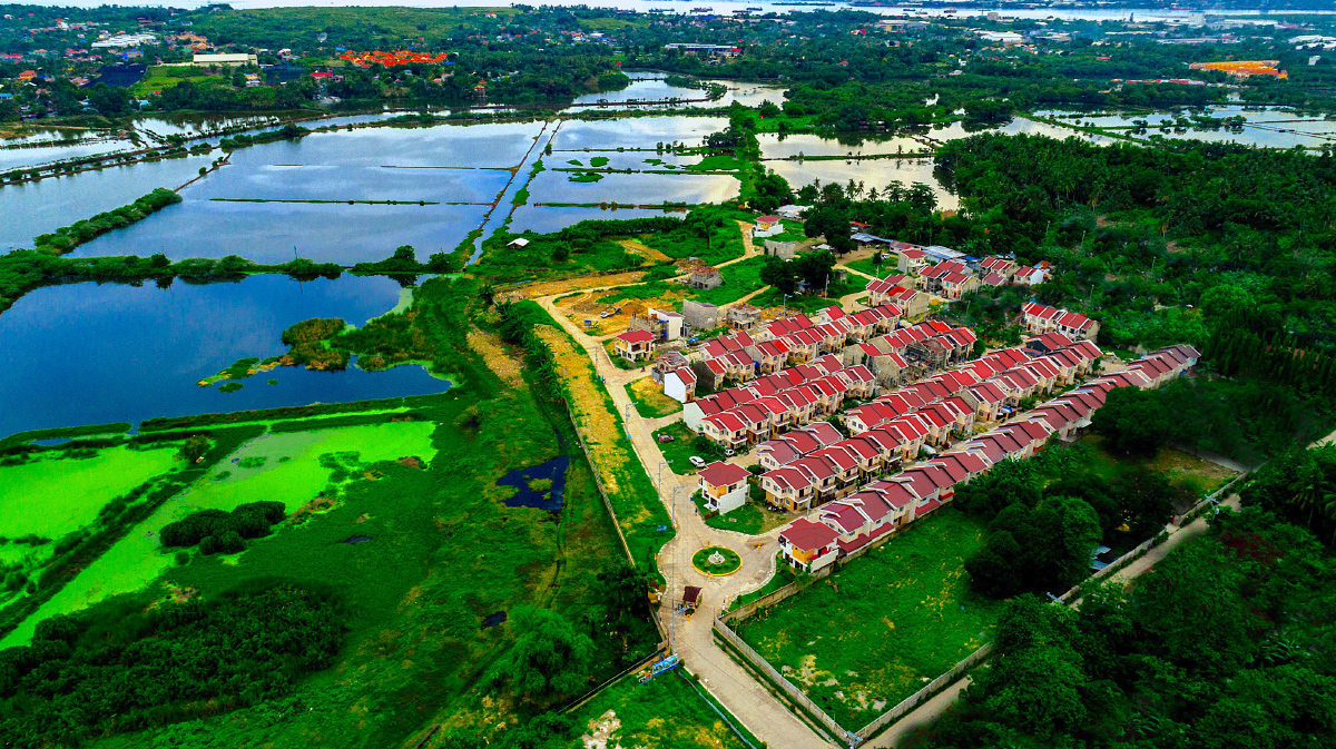 Aerial view of Anami Homes North beside open fields and water