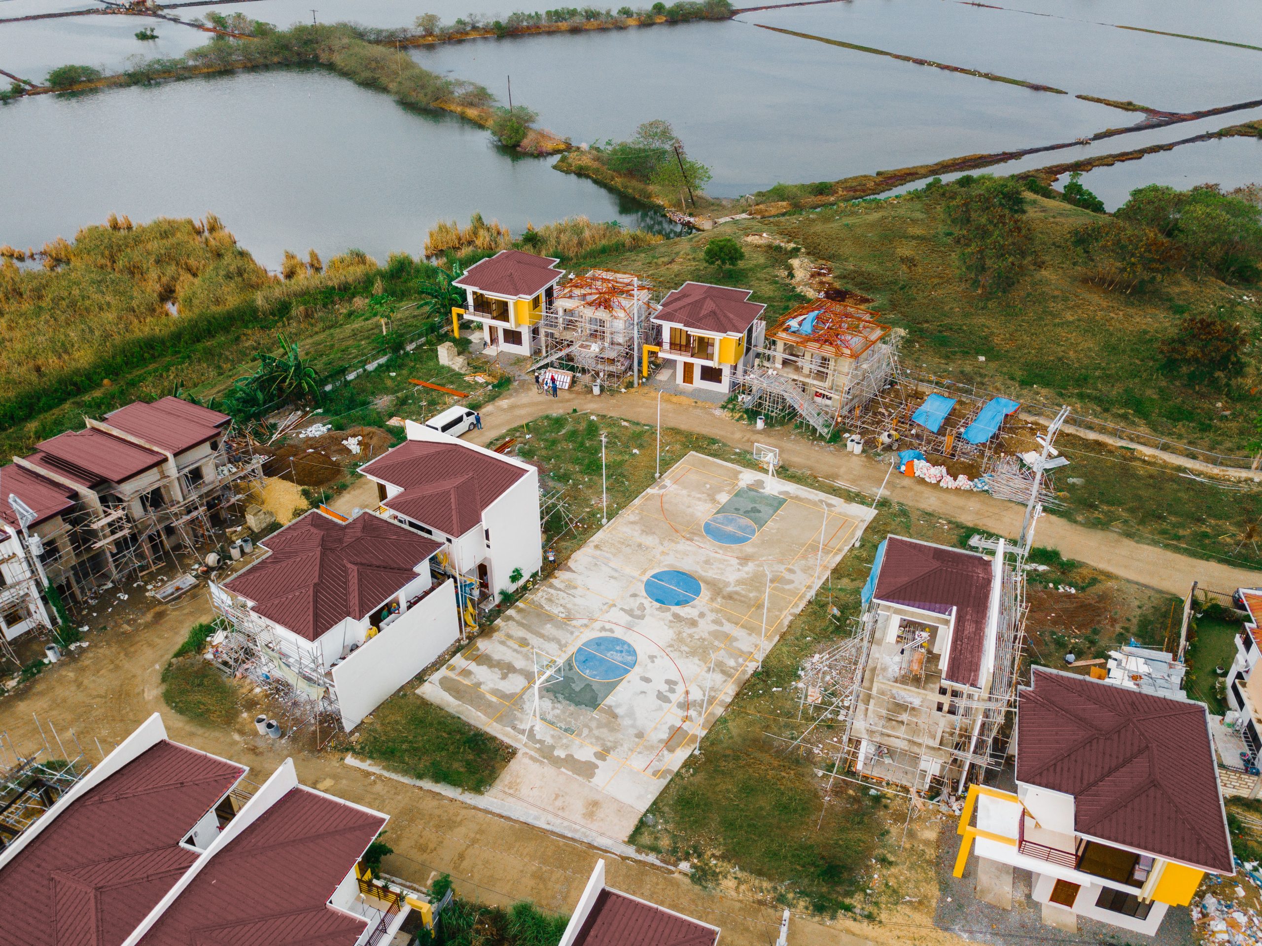 Aerial view of houses under construction at Anami Homes North, beside the water
